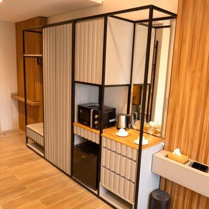 Modern and minimalist hotel room wardrobe and minibar area